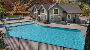 View of swimming pool featuring a hot tub and a patio area