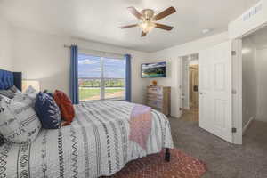 Carpeted bedroom featuring ceiling fan