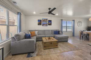 Living room featuring ceiling fan and recessed lighting