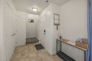Foyer featuring baseboards and light tile patterned flooring