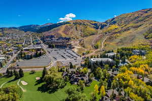 Aerial view of property and surrounding area featuring a mountain backdrop