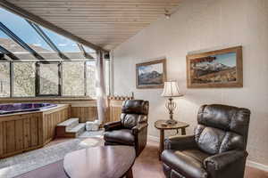 Sunroom featuring a jacuzzi, plenty of natural light, and vaulted ceiling