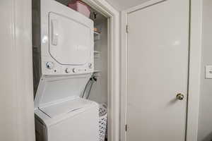 Washroom with stacked washer and clothes dryer
