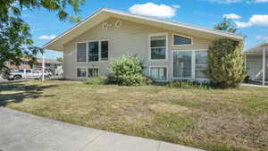View of side of property with a lawn