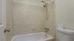 Bathroom with toilet and washtub / shower combination