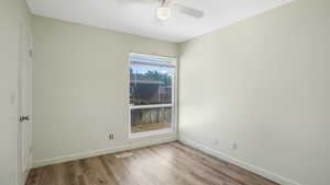 Empty room featuring wood finished floors and a ceiling fan