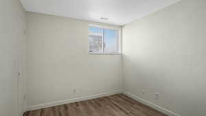 Empty room featuring wood finished floors and baseboards
