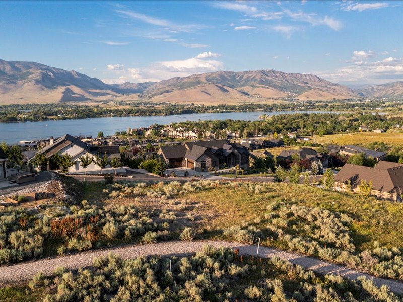 Mountain view featuring a nearby body of water and nearby suburban area