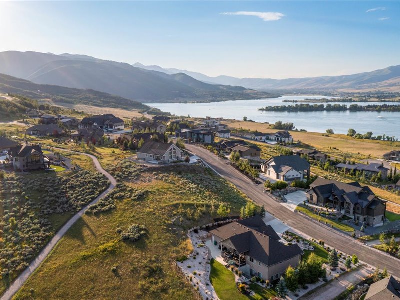 View of property location featuring a water and mountain view and nearby suburban area