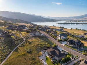 View of property location featuring a water and mountain view and nearby suburban area