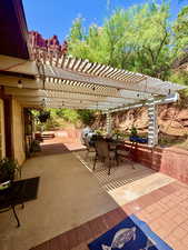 View of patio featuring a pergola and outdoor dining space