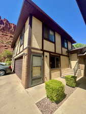 View of front facade featuring stucco siding, an attached garage, and driveway