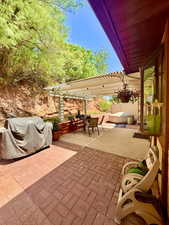 View of patio featuring a pergola, outdoor dining space, and grilling area