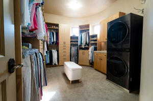 Laundry area featuring stacked washer and clothes dryer