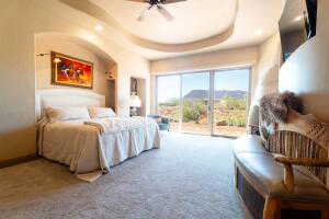 Bedroom with access to outside, carpet floors, and ceiling fan