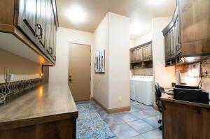 Kitchen featuring washer and clothes dryer and stainless steel countertops