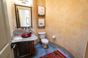 Half bath with vanity and tile patterned flooring
