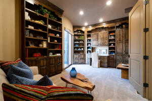 Living area with carpet floors and recessed lighting