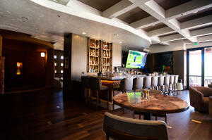 Interior space with coffered ceiling, wood finished floors, and beamed ceiling