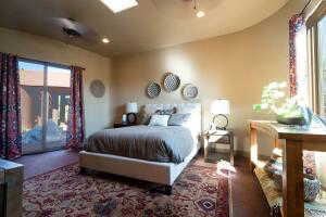 Bedroom with access to exterior, multiple windows, and recessed lighting
