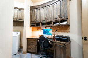 Home office featuring built in study area and washer / clothes dryer