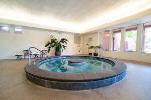 View of pool featuring a hot tub