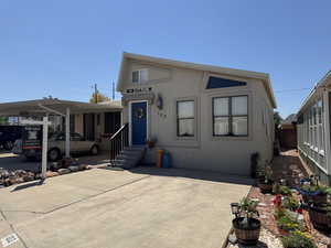 View of front of house featuring entry steps and stucco siding