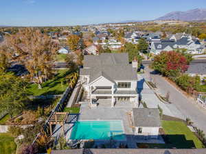 Aerial view of residential area with a pool area and a mountain backdrop