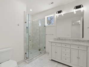 Full bathroom featuring double vanity, a stall shower, recessed lighting, and light marble finish floors