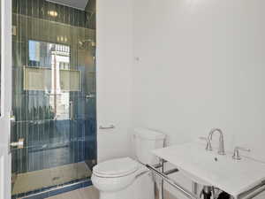 Bathroom featuring toilet and a stall shower