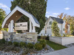 Community / neighborhood sign featuring a garage