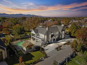 Aerial view at dusk of view of pool and a mountain view