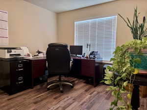 Bedroom used as an office featuring dark wood-type flooring