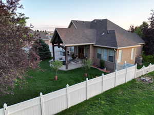 Back of house with a patio, a shingled roof, stucco siding, and a fenced backyard