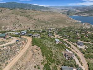 Aerial view of property and surrounding area featuring a water and mountain view