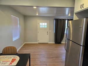 Entryway with light wood-style flooring and baseboards
