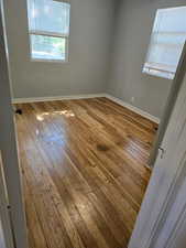 Unfurnished room with hardwood / wood-style flooring