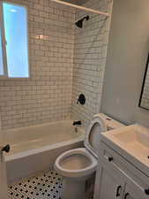 Bathroom featuring vanity, shower / washtub combination, and tile patterned floors