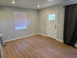 Foyer entrance featuring wood finished floors and recessed lighting