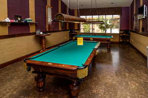 Community Center Recreation room with billiards table and wallpapered walls