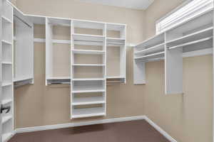 Primary walk-in closet with custom shelving