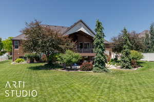 Back of property featuring a balcony, brick siding, and a patio