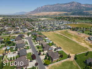 Aerial view of property and surrounding area featuring nearby suburban area
