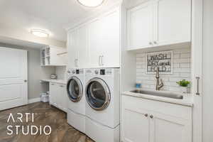 Laundry area featuring independent washer and dryer and cabinet space