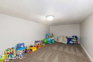 Rec room featuring carpet flooring and baseboards