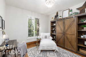 Bedroom with light wood-style floors and a chandelier