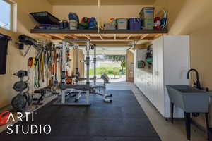 Workout room with a sink and a garage