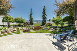 View of patio with an outdoor fire pit and a mountain view
