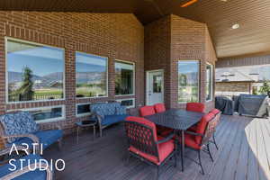 Wooden deck with a mountain view and grilling area