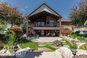Rear view of property with brick siding, stairs, an outdoor fire pit, and a patio area